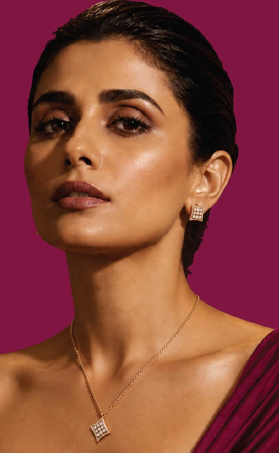 Model wearing a DIAGO diamond pendant and earrings